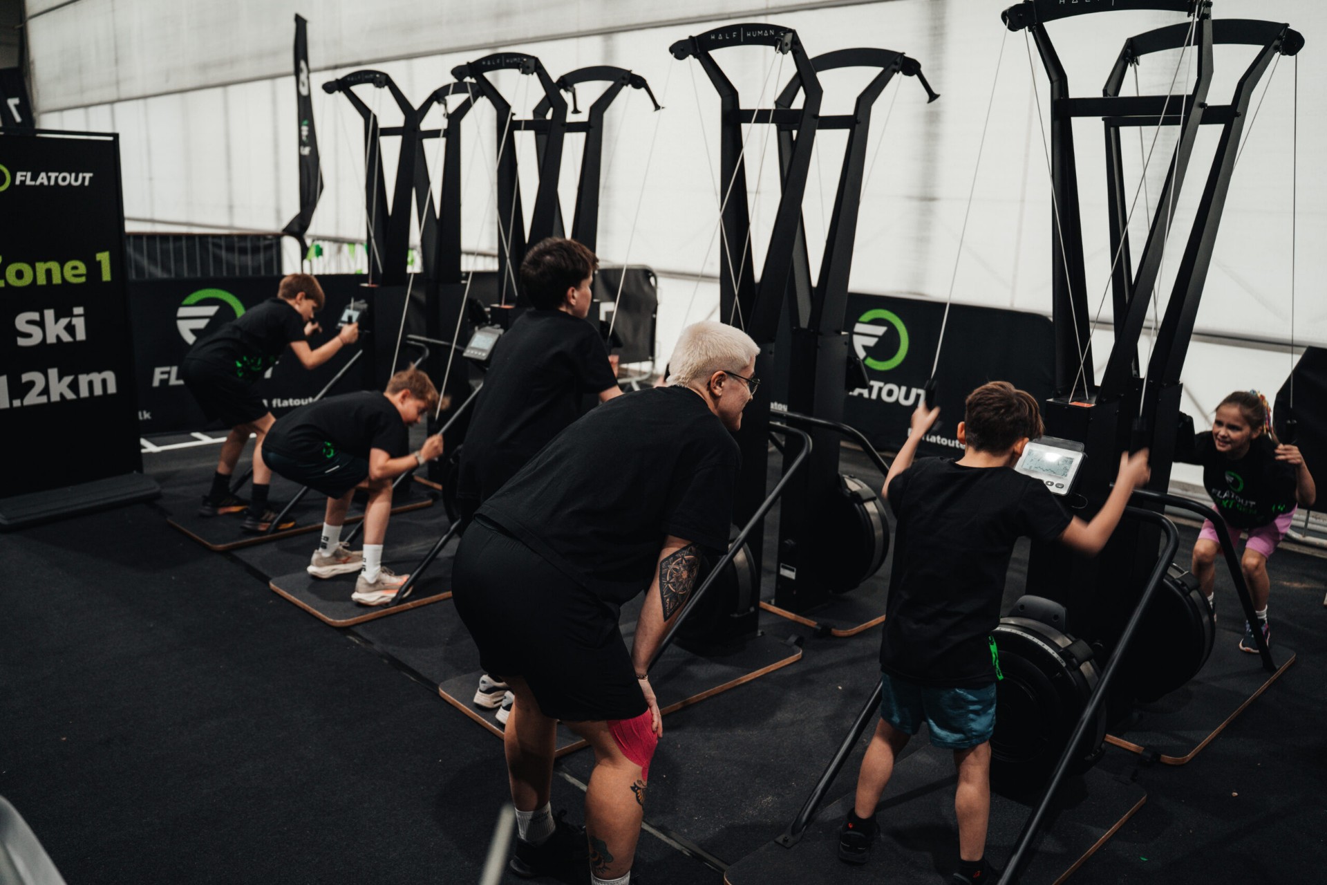 Sidekicks teams pushing through a ski erg zone together